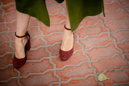 the girl's hands are tying a scarfの写真素材