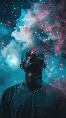 A man is standing in front of a blue background with smoke coming out of his mouth. The smoke is creating a hazy effect, making the man look like he is in a dream or a surreal worldの素材