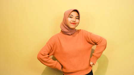 Young asian muslim woman wearing hijab smiling and looking at cameraの写真素材