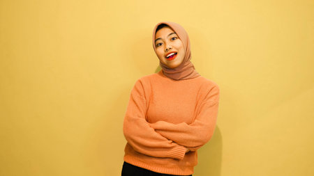 Portrait of a happy young asian muslim woman wearing hijabの写真素材