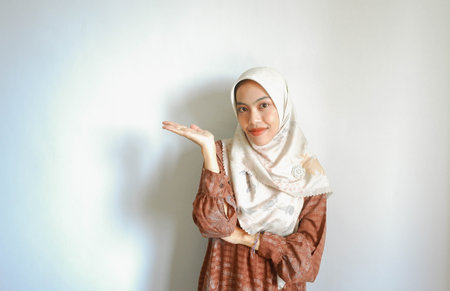 happy young asian woman in casual shirt. Charming female lady open hands palm up holding something...