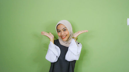 happy young asian woman in casual shirt. Charming female lady open hands palm up holding something...