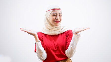 Excited young Asian woman celebrate Indonesian independence day on 17 August, pointing at the copy...