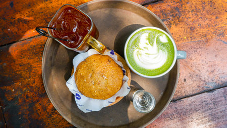 Top View of Green tea latte, iced tea, and cookies on wooden tableの写真素材