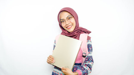 Young asian girl teen student, backpack hold books isolated on white background. Education in high school university college concept. Mock up copy spaceの写真素材