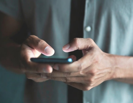 Man using mobile smart phone. Close up of male hands using smartphone.