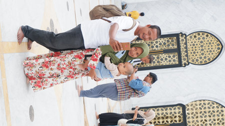 high angle view of muslim family taking selfie with smartphone at mosque