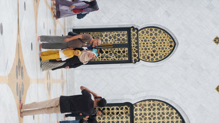 Top view of Muslim people praying inside Sheikh Zayed Grand Mosque in Abu Dhabi, United Arab...