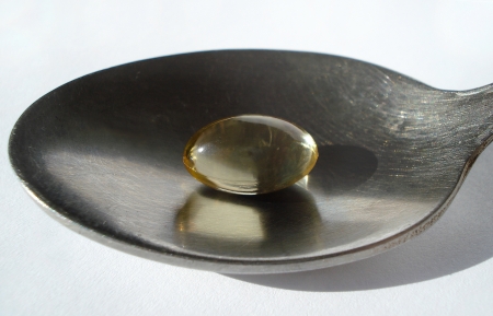 Fish oil capsule on a spoon     の写真素材