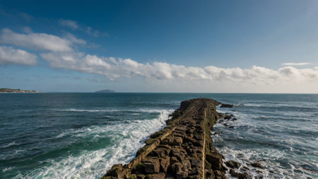 Waves breaking on the breakwater at the coast of the Atlantic Oceanの写真素材