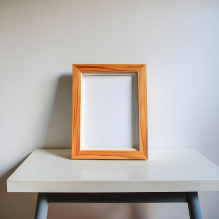 Empty picture frame on white table and white wall background, stock photo