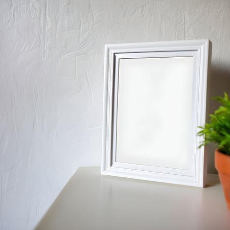 Blank white picture frame on white table and white wall background.の写真素材