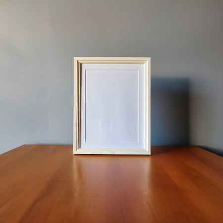 White picture frame on wooden table and gray wall background, stock photoの写真素材