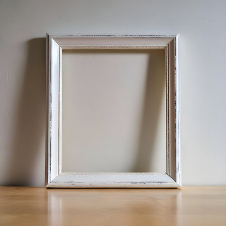 White wooden picture frame on the wooden floor and white wall background.