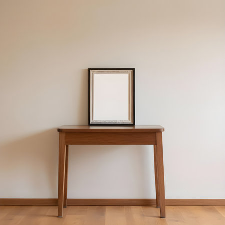 Empty picture frame on a wooden table in a room. Nobody insideの写真素材