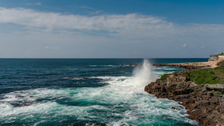 Panoramic view of the ocean waves crashing on the rocks.の写真素材