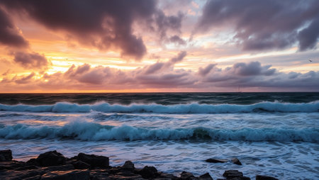 Sunset over the sea with clouds in the sky and stormy waves