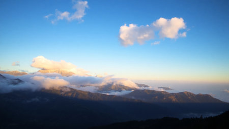 Mountains in the clouds at sunset. View from the top of the mountain.