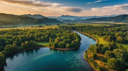 Aerial view of beautiful landscape with river and mountains at sunset.