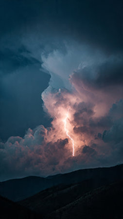 Lightning strike in the sky with clouds. Thunderstorm over the mountainsの写真素材