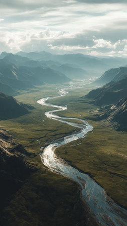 Aerial view of a small river flowing through a valley in Alaska.の写真素材