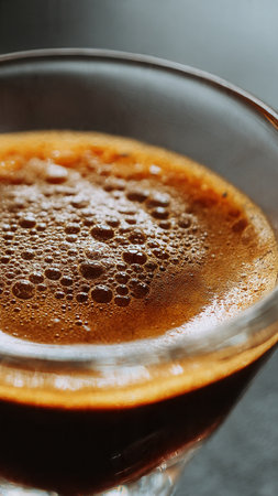 coffee in a glass on a dark background, close-upの写真素材