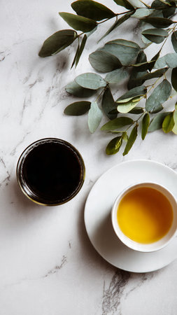 Cup of tea and eucalyptus branchle backgroundの写真素材