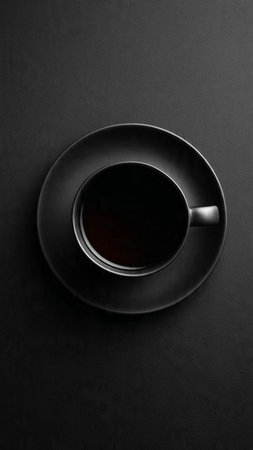 Black cup of coffee on black background. Top view, flat layの写真素材