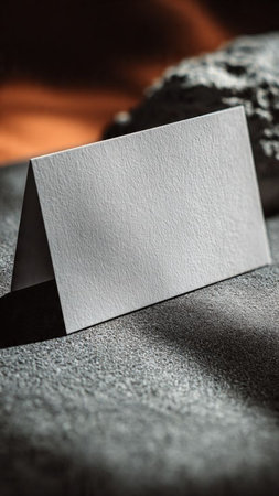 Photo of blank business card on stone background. Mockup for branding identity.の写真素材