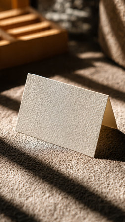 Blank business card on carpet in sunlight. Mockup for branding identity.の写真素材