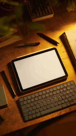 Tablet with blank screen and keyboard on wooden table in office.の写真素材
