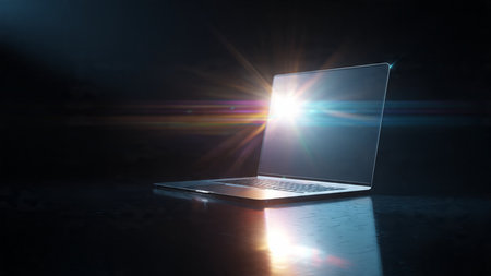 Laptop computer on dark background with sun rays. 3d renderingの写真素材