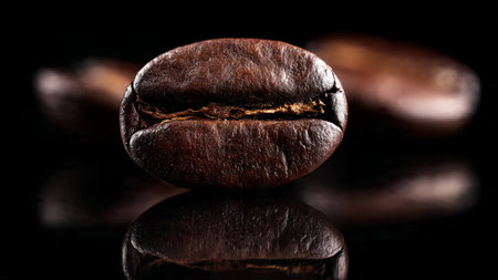 roasted coffee beans on a black background with reflection, close-upの写真素材