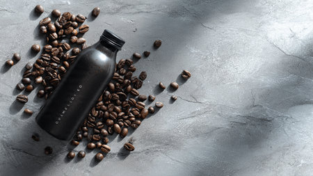 Coffee beans and a bottle of coffee on a gray background