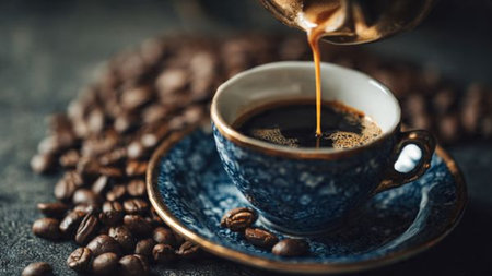 Coffee in a blue cup and coffee beans on a dark background
