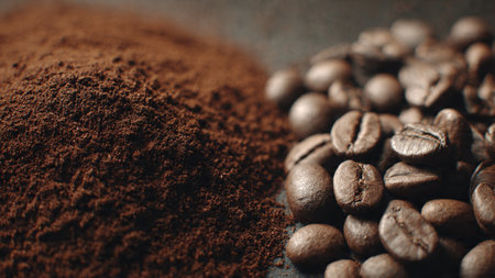 Coffee beans and ground coffee on a rustic background.の写真素材