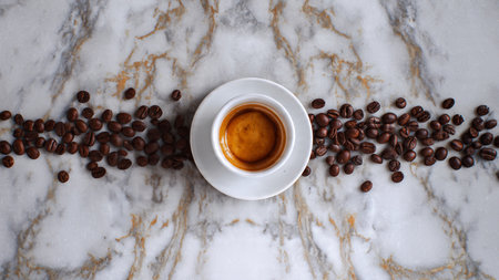 Cup of espresso with coffee beansle background. Top viewの写真素材