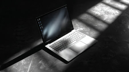 Laptop with shadow on a black background. 3d rendering.