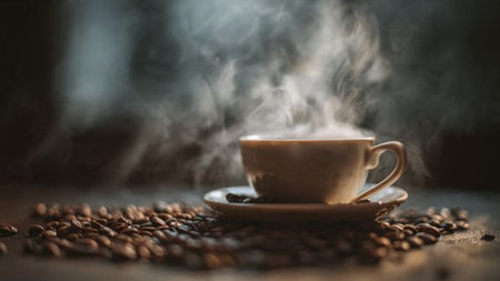 Coffee cup and coffee beans on the wooden table with smoke
