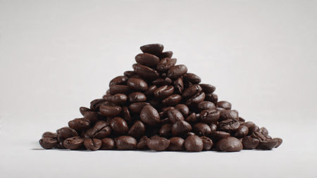 Coffee beans in a pyramid shape on a white background.の写真素材