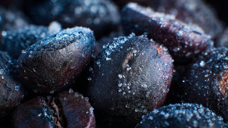 Close up of roasted coffee beans with sugar crystals. Macro shot.