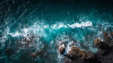 Aerial view of ocean waves crashing on the rocks in Tenerifeの写真素材