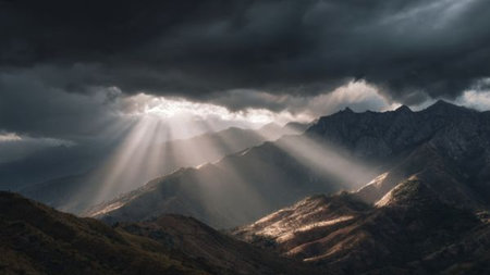 Sun rays shining through the clouds over the mountains. Panorama.の写真素材