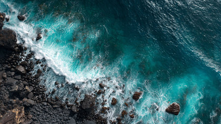 Aerial view of the ocean waves crashing on the rocks in Lanzarote