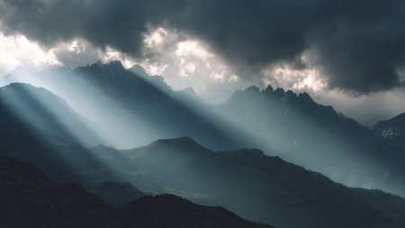 Sunbeams shining through the clouds over the mountains. Caucasus, Russiaの写真素材