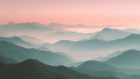 Landscape of mountains in the mist at dawn. Beautiful natural background.の写真素材