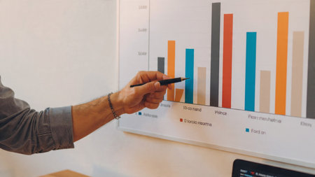 A digital market analysis station with coffee and reports surrounding a laptop.の写真素材