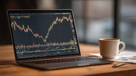 A wooden workspace with real-time stock analysis and hot coffee for productivity.の写真素材