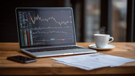 A wooden workspace with real-time stock analysis and hot coffee for productivity.の写真素材