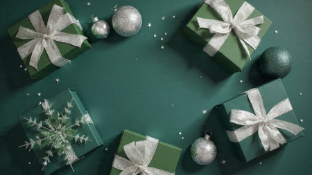A cinematic Christmas composition featuring cool green ornaments and glowing silver stars.の写真素材